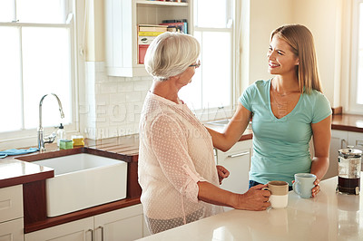 Buy stock photo Mother, coffee or happy woman speaking in kitchen in family home bonding or enjoying quality time together. Affection, retirement or daughter talking, relaxing or drinking tea with senior parent