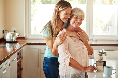 Buy stock photo Mother, coffee or happy woman hugging in kitchen in family home bonding to enjoy time together. Embrace, affection or funny daughter relaxing or drinking tea with senior parent or mom in retirement