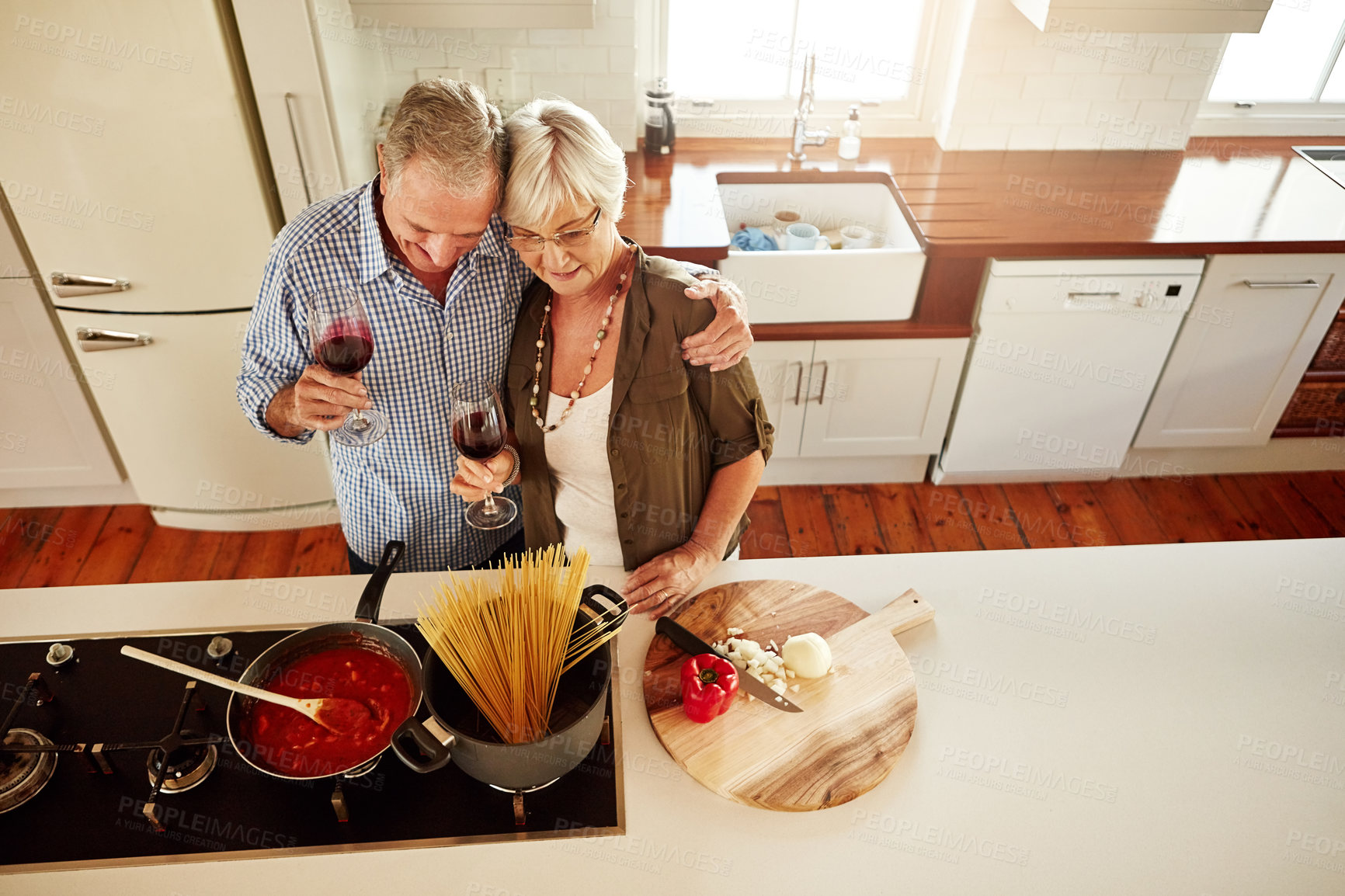 Buy stock photo Hugging, wine or old couple cooking food for a healthy vegan diet together with love in retirement at home. Top view of senior woman drinking or bonding in house kitchen with mature husband at dinner