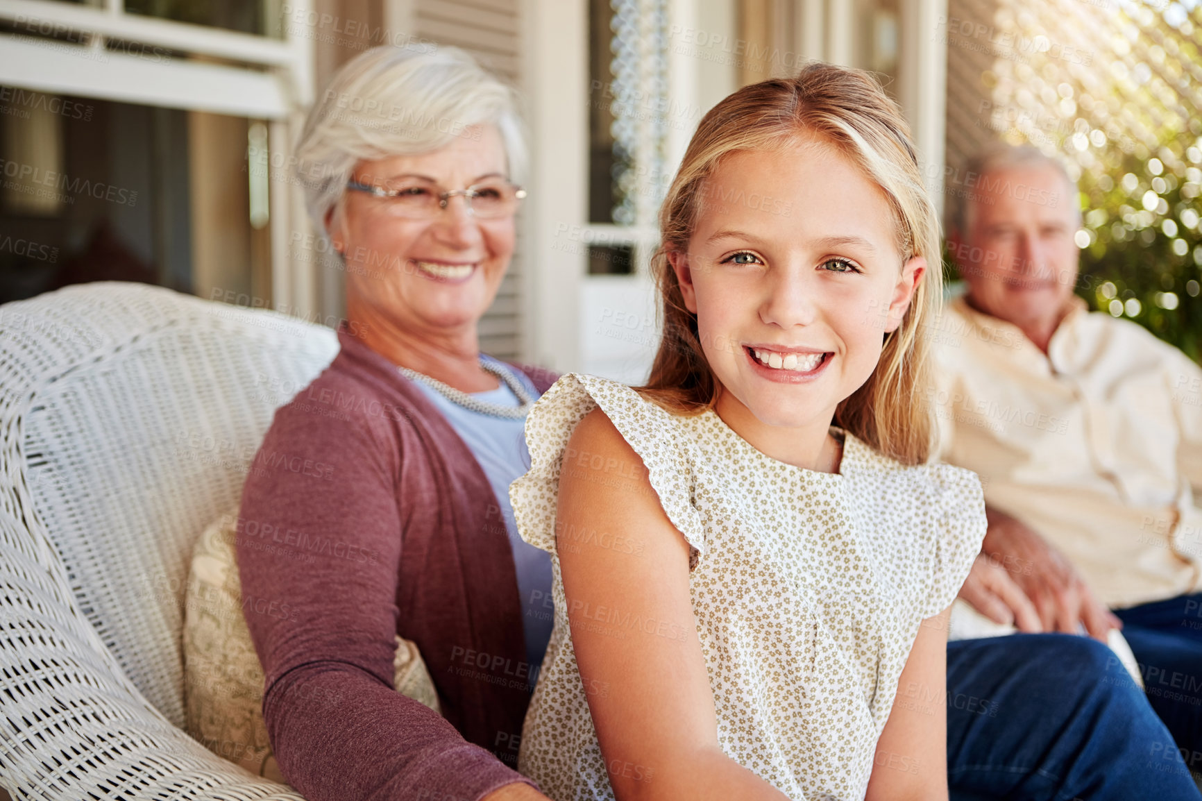 Buy stock photo Cropped portrait of a young girl sitting outside with her grandparents