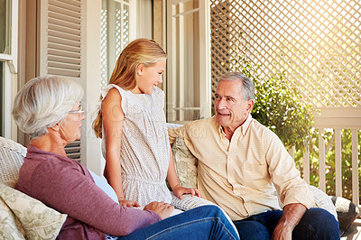 Buy stock photo Cropped shot of a young girl standing outside with her grandparents