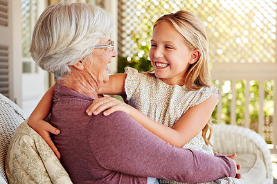 Buy stock photo Cropped shot of a young girl sitting outside with her grandmother