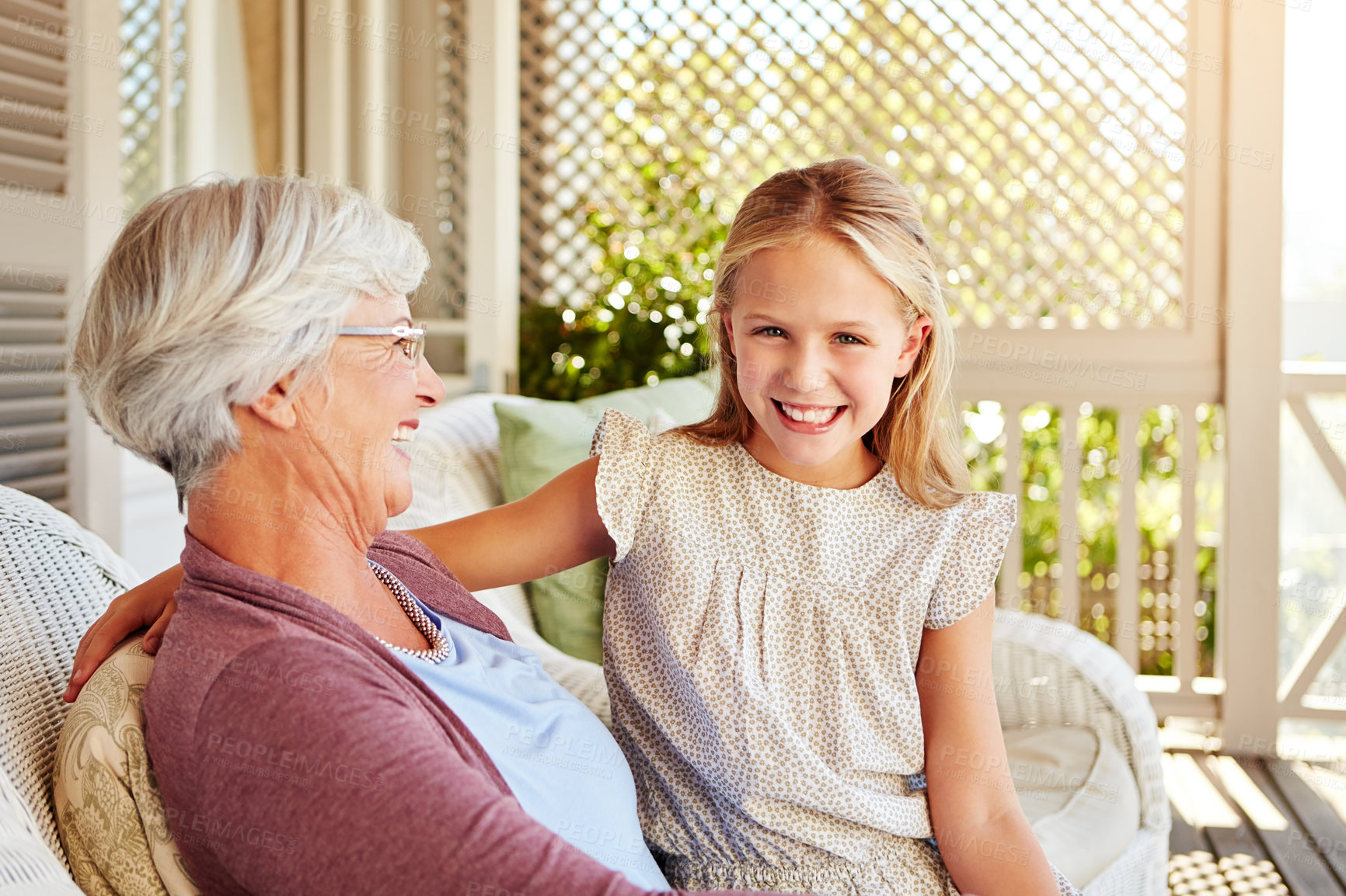 Buy stock photo Cropped portrait of a young girl sitting outside with her grandmother