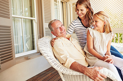 Buy stock photo Cropped shot of a young girl sitting outside with her mother and grandfather