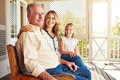 Buy stock photo Cropped shot of a young girl sitting outside with her mother and grandfather