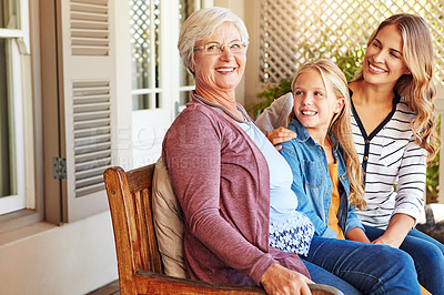 Buy stock photo Cropped shot of a young girl sitting outside with her mother and grandmother