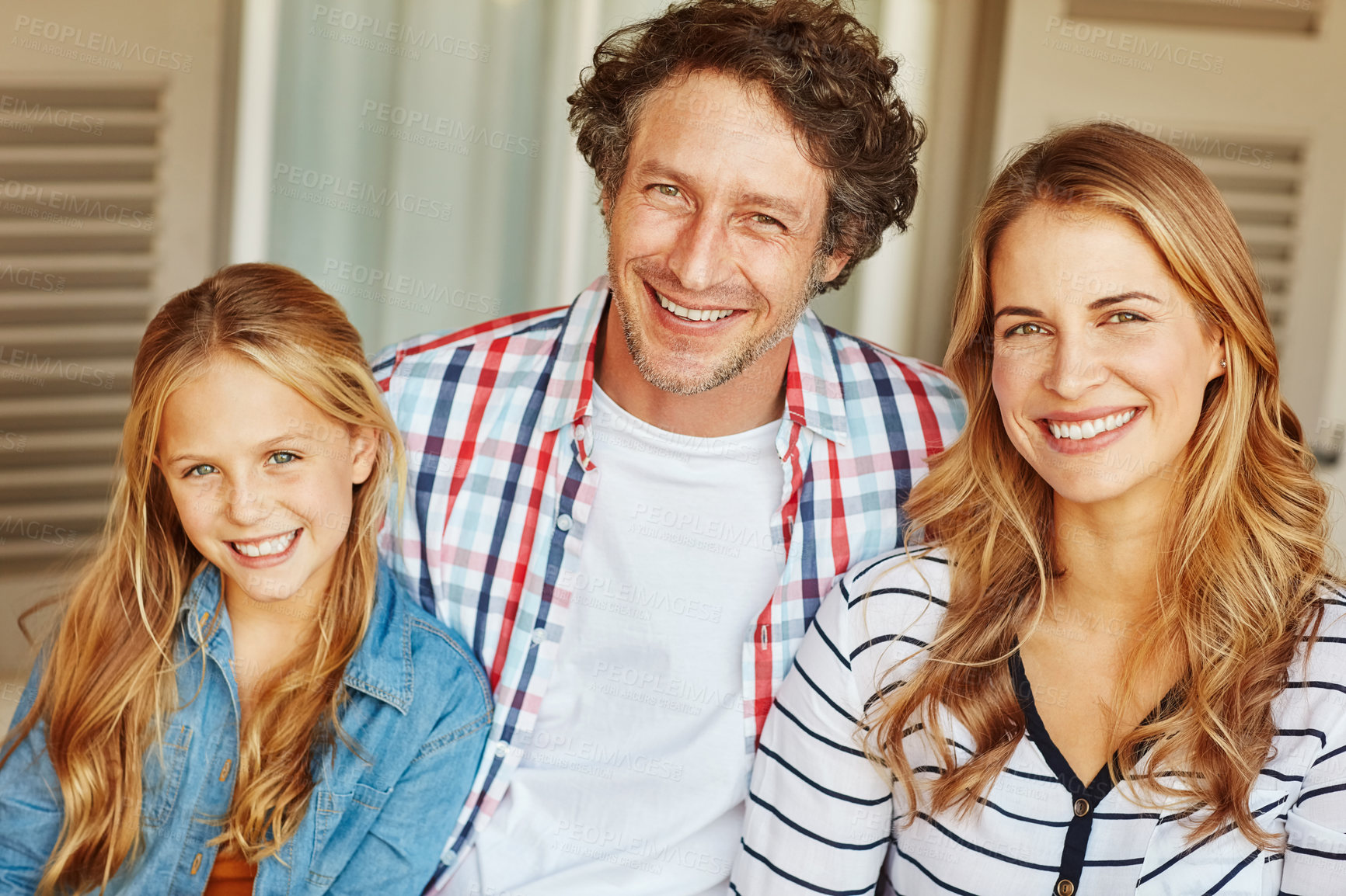 Buy stock photo Cropped portrait of a young girl sitting outside with her mother and father