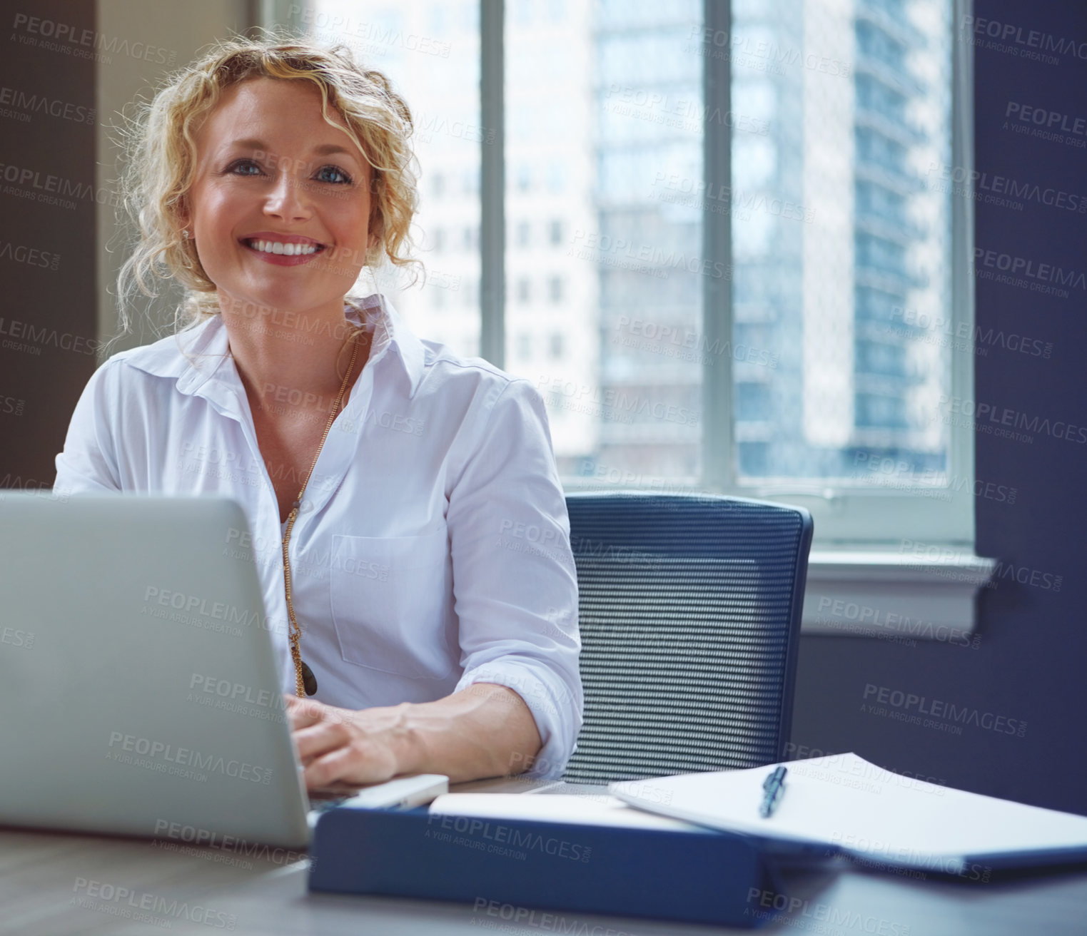Buy stock photo Shot of a businesswoman using a laptop in an office