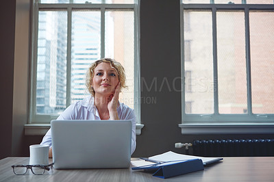 Buy stock photo Shot of a businesswoman using a laptop in an office