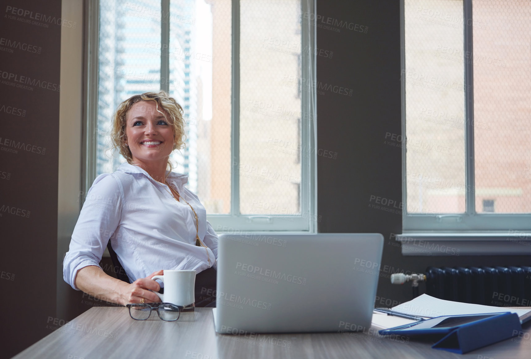 Buy stock photo Shot of a businesswoman taking a break at her desk in an office