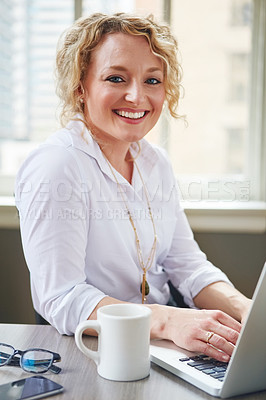 Buy stock photo Portrait of a businesswoman using a laptop in an office