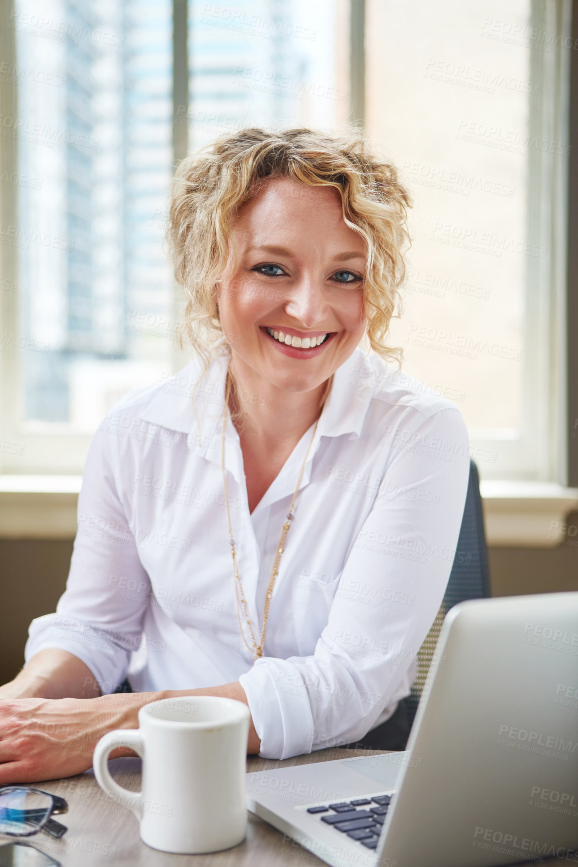 Buy stock photo Portrait of a businesswoman working at her desk in an office