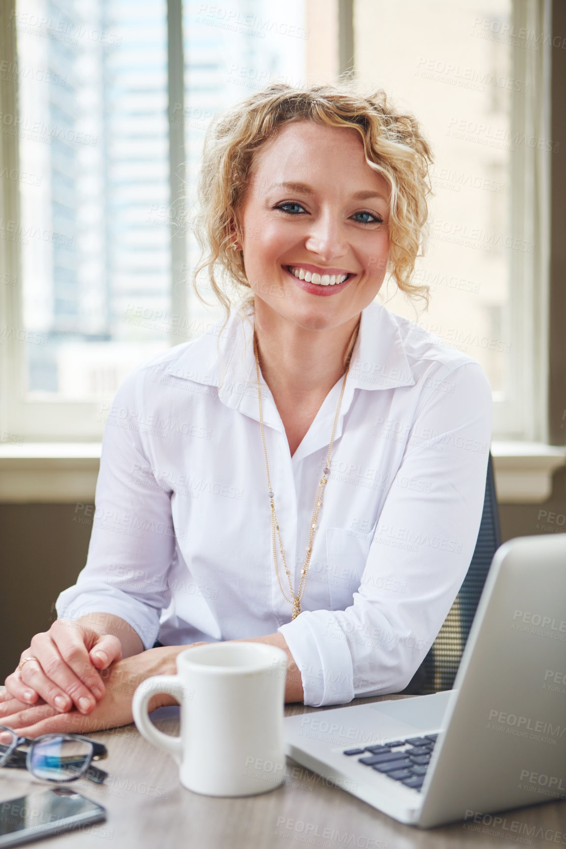 Buy stock photo Portrait of a businesswoman working at her desk in an office