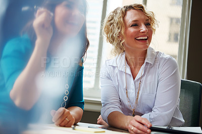 Buy stock photo Shot of two businesswomen having a meeting together in an office