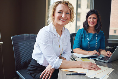 Buy stock photo Portrait of two businesswomen having a meeting together in an office