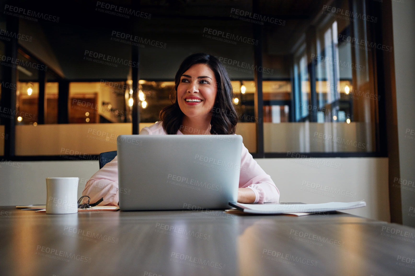 Buy stock photo Shot of a smiling businesswoman working on a laptop in an office