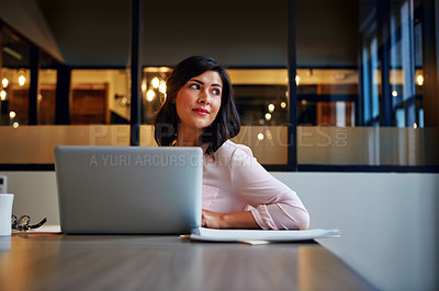 Buy stock photo Shot of a businesswoman daydreaming while working on a laptop in an office