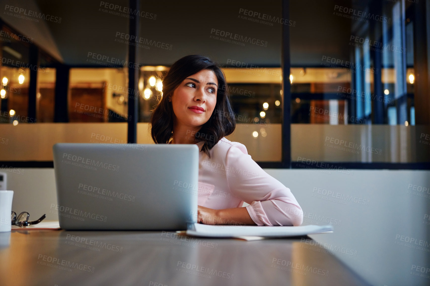 Buy stock photo Shot of a businesswoman daydreaming while working on a laptop in an office