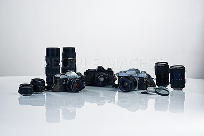 Buy stock photo Studio shot of various cameras and their accessories