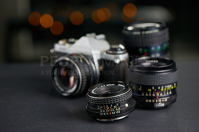 Buy stock photo Studio shot of a camera and various lenses