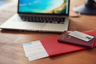 Buy stock photo Shot of travel documents and a laptop on a table