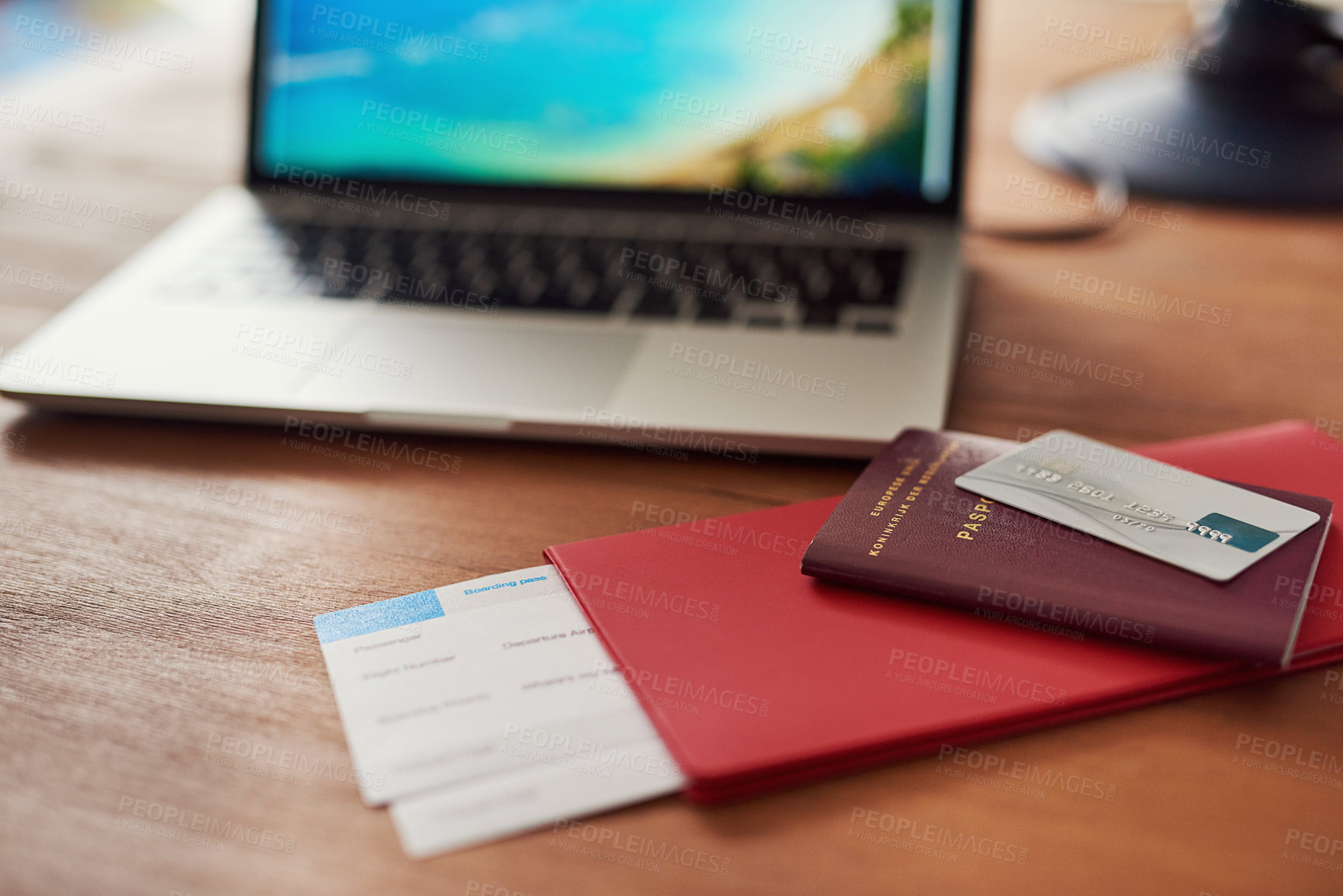 Buy stock photo Shot of travel documents and a laptop on a table