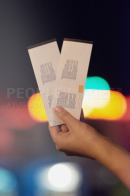 Buy stock photo Shot of an unrecognizable person holding up two tickets