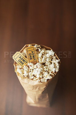 Buy stock photo Popcorn, movie tickets and cinema food with event, entertainment and top view for date. Concert, film festival or circus show with corn snack for nutrition, paper bag and vintage coupon at theatre