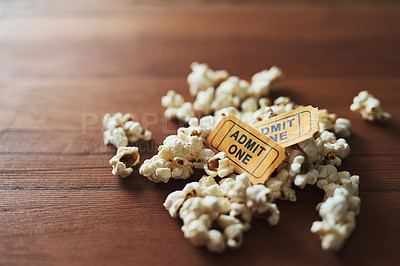 Buy stock photo Shot of a pile of popcorn and two movie tickets