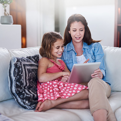 Buy stock photo Mother, girl child and relax with tablet for streaming, elearning or online games with bonding or together at family home. Happy, love and woman on break with daughter, connection and ebook with tech