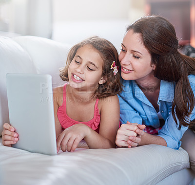 Buy stock photo Mother, girl and kid on sofa with tablet for streaming, elearning or online games with bonding or together at family home. Happy, love and woman on break with daughter, connection and ebook with tech