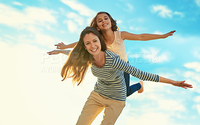 Buy stock photo Shot of a mother and her daughter playing outside