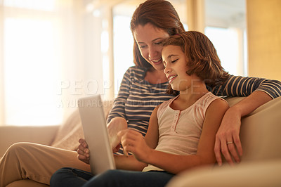 Buy stock photo Mother, child and sofa with tablet for streaming movies, happiness and bonding together in living room. Family, mom and young girl with technology for e learning, education or social media in home