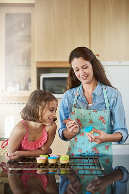 Buy stock photo Mother, child and cupcakes baking in home or icing dessert as decorations, learning or bonding. Woman, daughter and teaching at kitchen counter for sweets snack or recipe support, helping or love