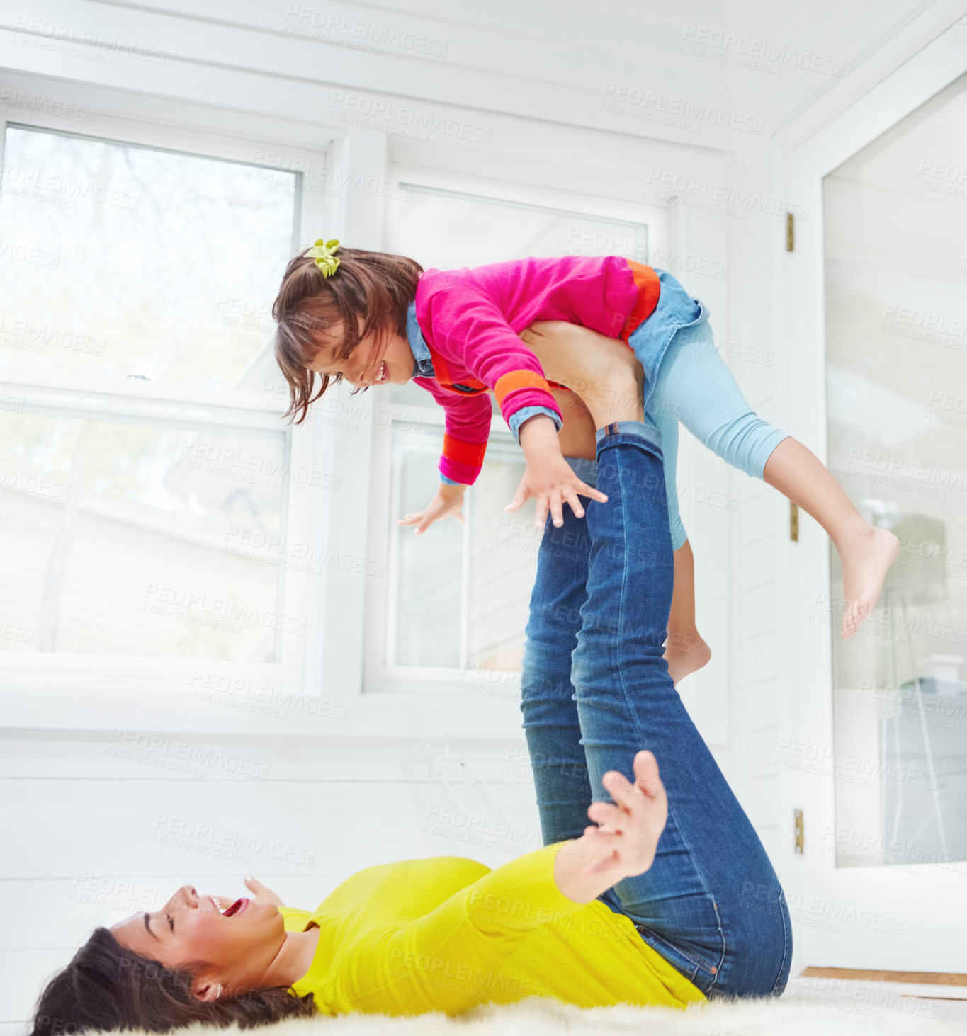 Buy stock photo Shot of an adorable little girl and her mother having fun at home