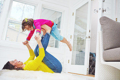 Buy stock photo Shot of an adorable little girl and her mother having fun at home