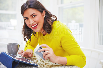 Buy stock photo Portrait of a woman using her tablet and credit card at home