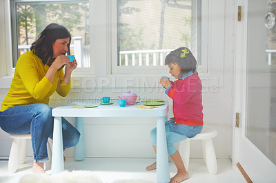 Buy stock photo Shot of an adorable little girl having a tea party with her mother at home
