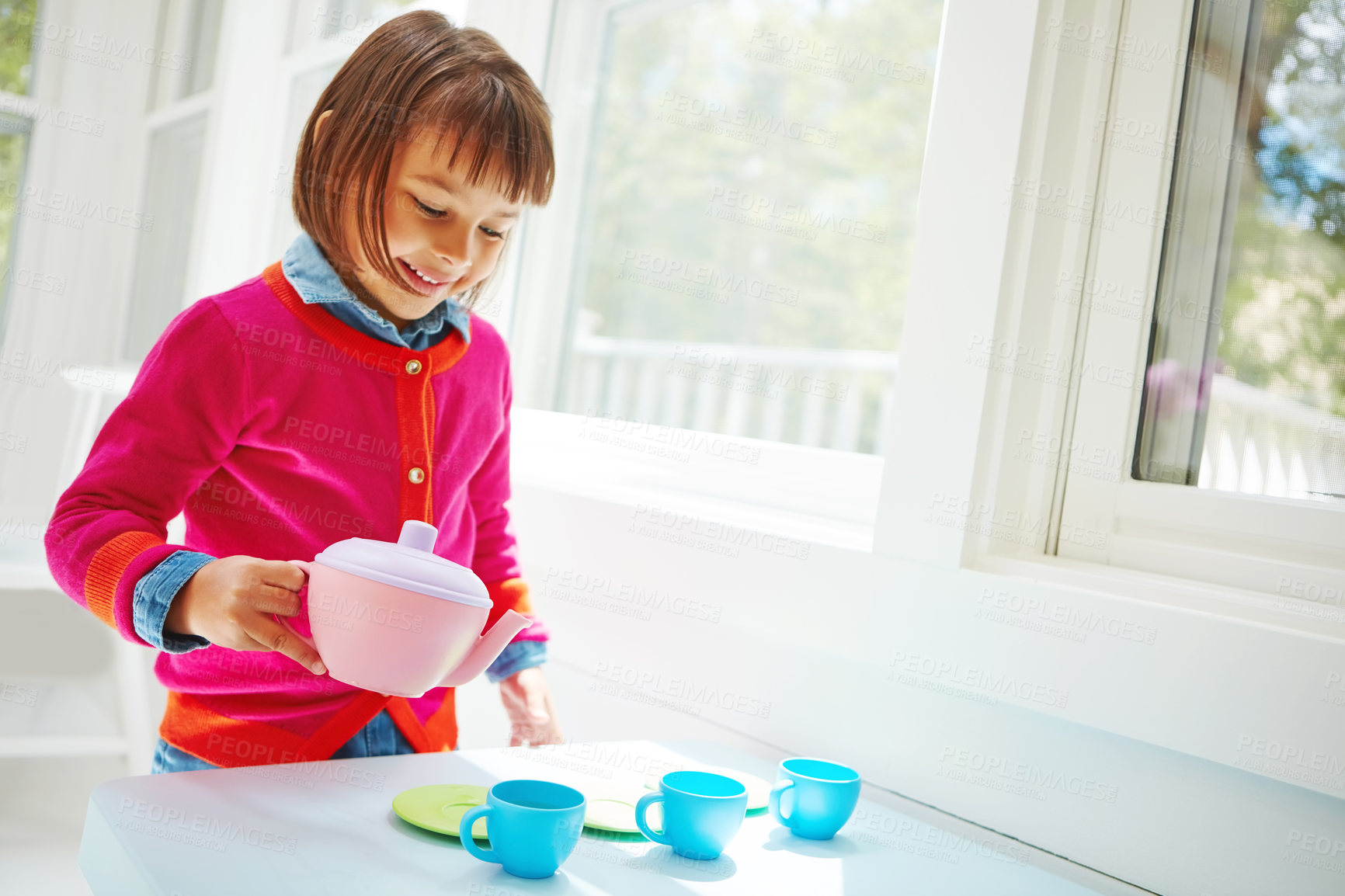 Buy stock photo Shot of an adorable little girl having a tea party at home