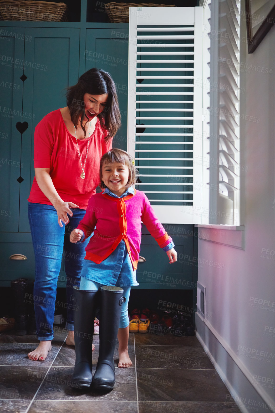 Buy stock photo Mother, happy and child with boots in home for role play, imagination fun and bonding together. Woman, portrait and kid with big footwear for games, imitation and curiosity of childhood development