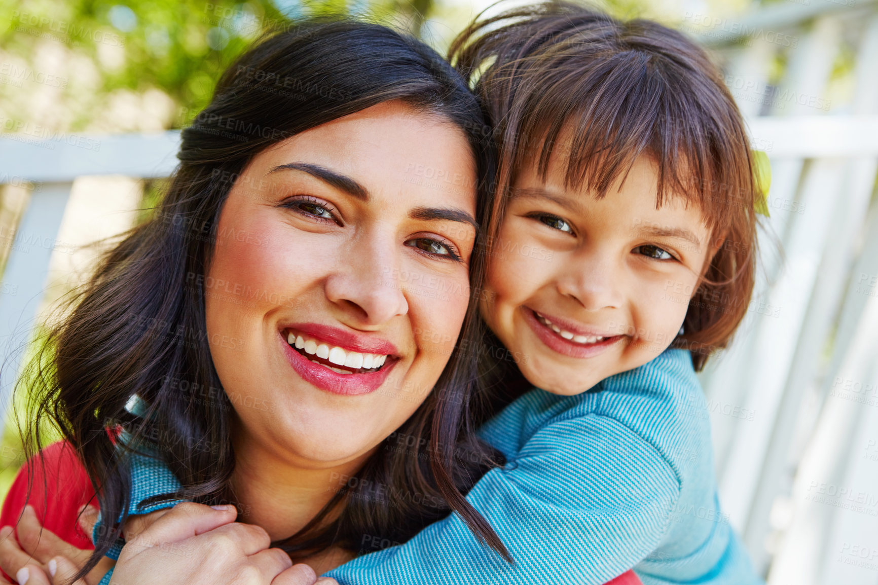 Buy stock photo Cropped shot of a mother receiving a hug from her daughter outside