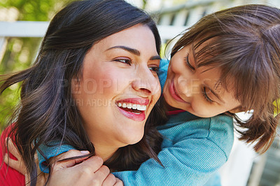 Buy stock photo Cropped shot of a mother receiving a hug from her daughter outside