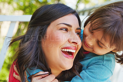 Buy stock photo Cropped shot of a mother receiving a hug from her daughter outside