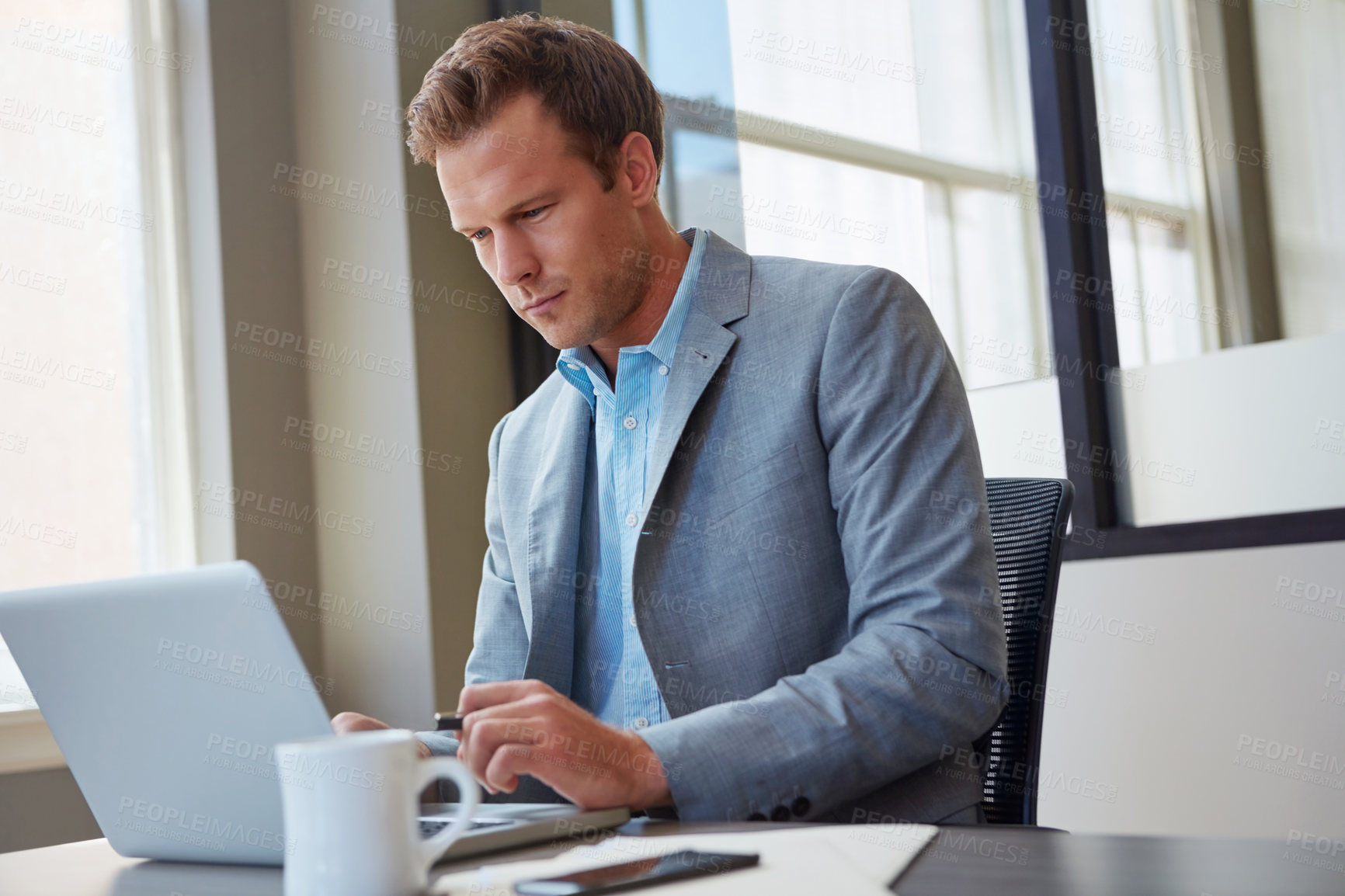 Buy stock photo Cropped shot of a businessman working in his office