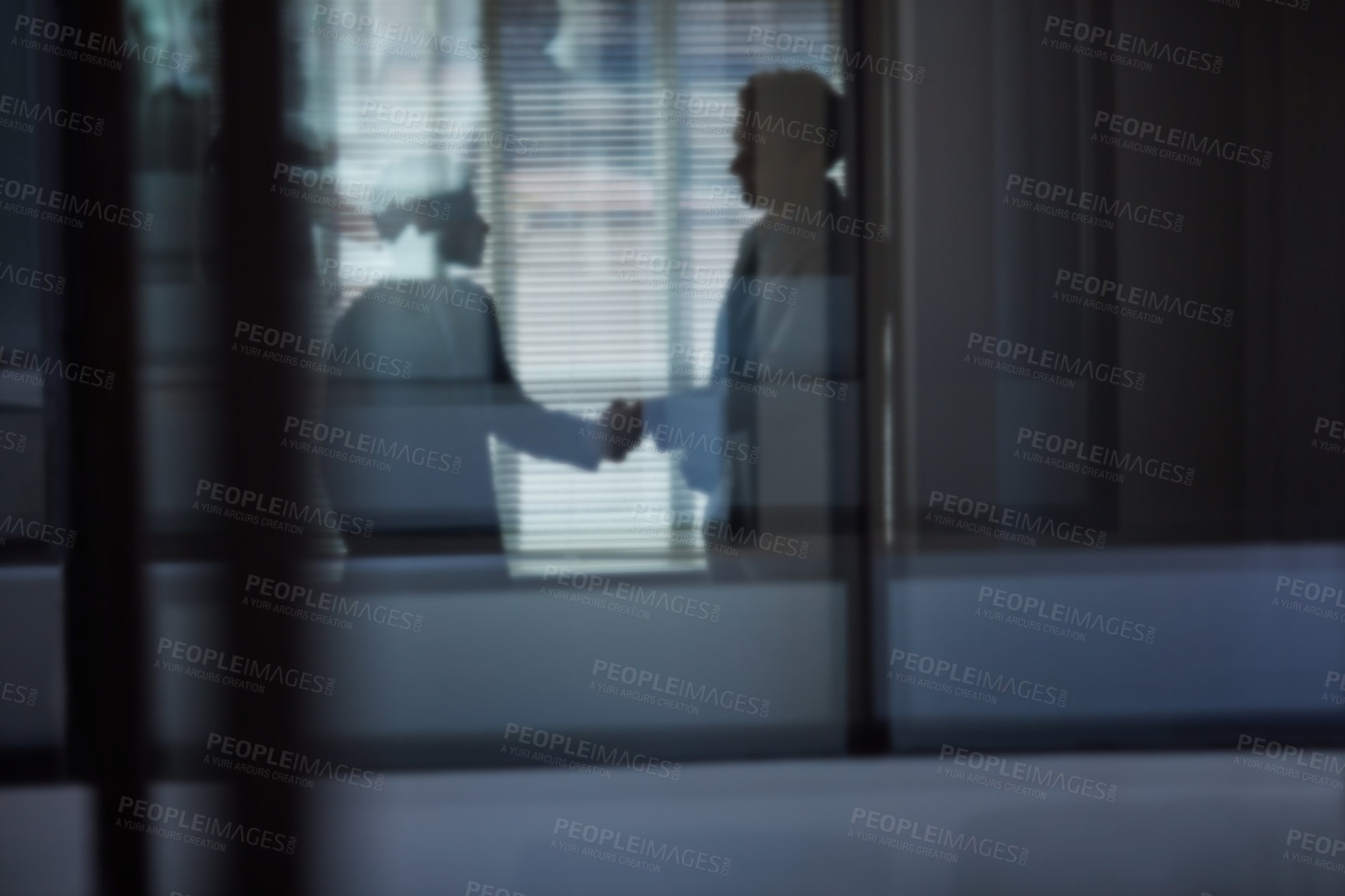 Buy stock photo Cropped shot of two businessmen shaking hands in the office