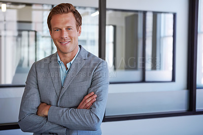 Buy stock photo Cropped portrait of a businessman standing with his arms folded in his office