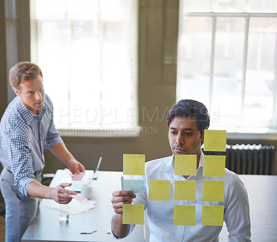 Buy stock photo Cropped shot of two businessmen preparing for a presentation by using adhesive notes