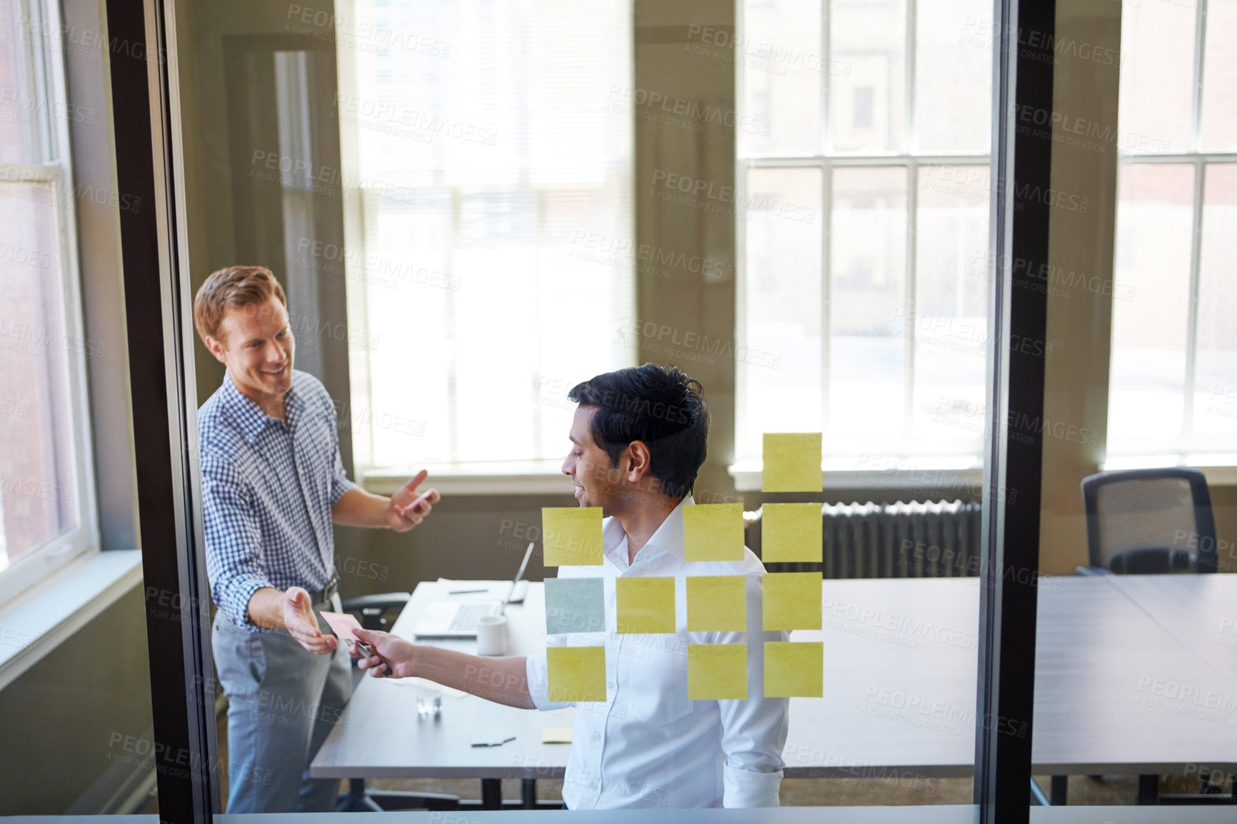 Buy stock photo Cropped shot of two businessmen preparing for a presentation by using adhesive notes