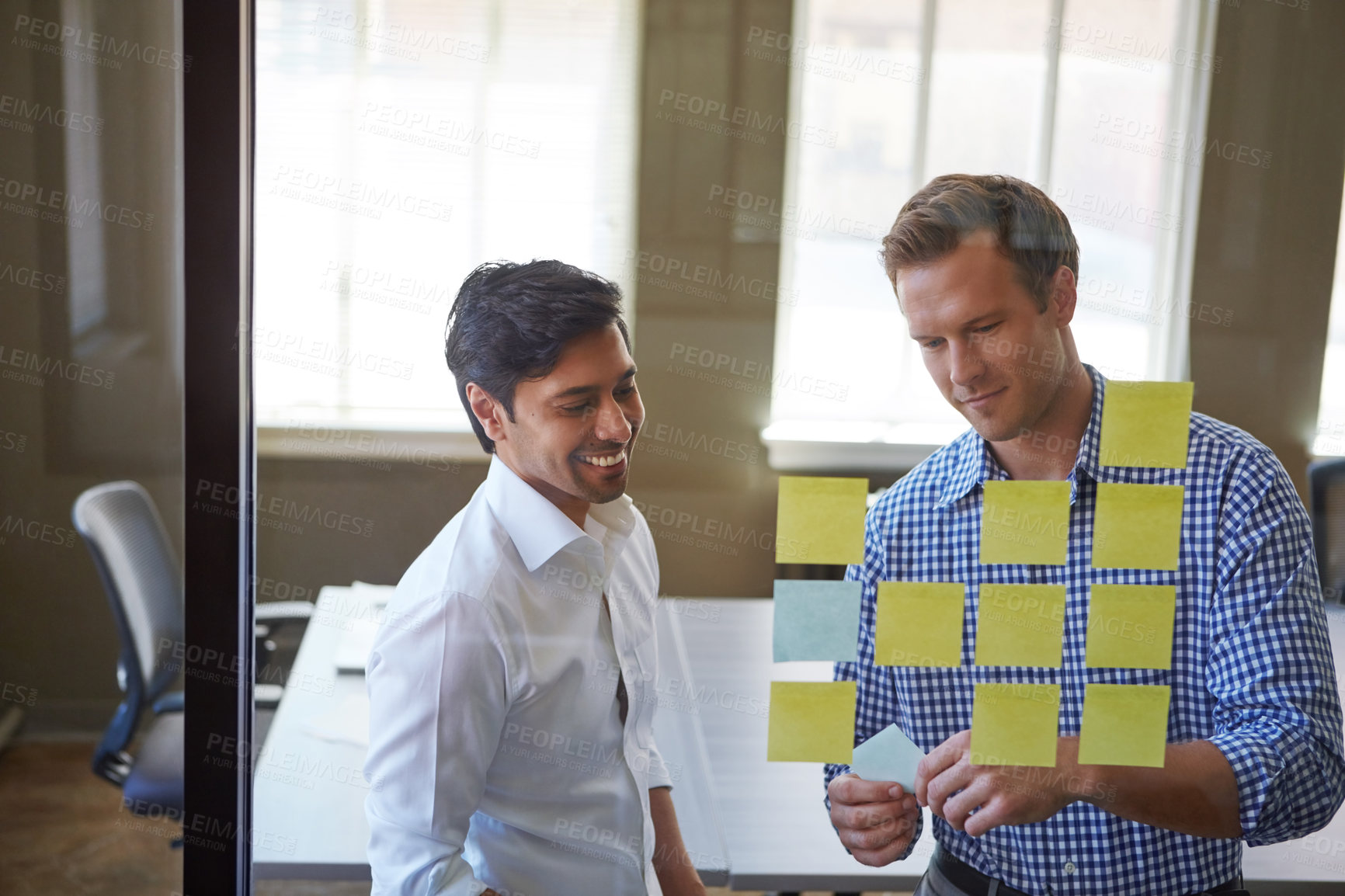 Buy stock photo Cropped shot of two businessmen preparing for a presentation by using adhesive notes