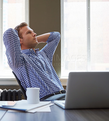 Buy stock photo Shot of a worried businessman leaning back in his chair